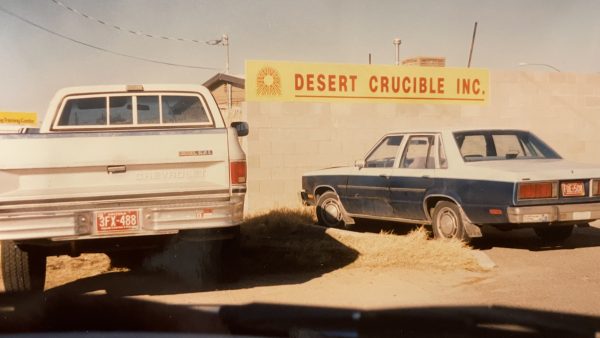 Yellow sign that says Desert Crucible, Inc.